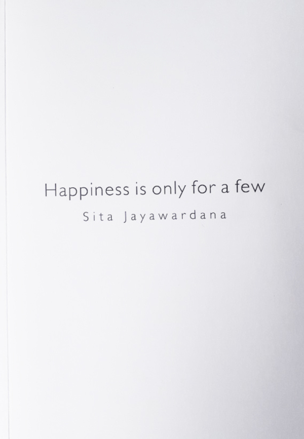 Text on a white page reads: "Happiness is only for a few" by Sita Jayawardana.